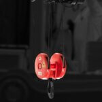 Hook Block Carrusel web Red crane hook block suspended from overhead hoist for lifting operations