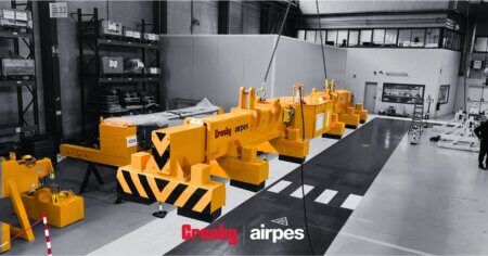 Overhead electromagnet lifting heavy steel components in an industrial workshop using a crane system by Crosby Airpes.