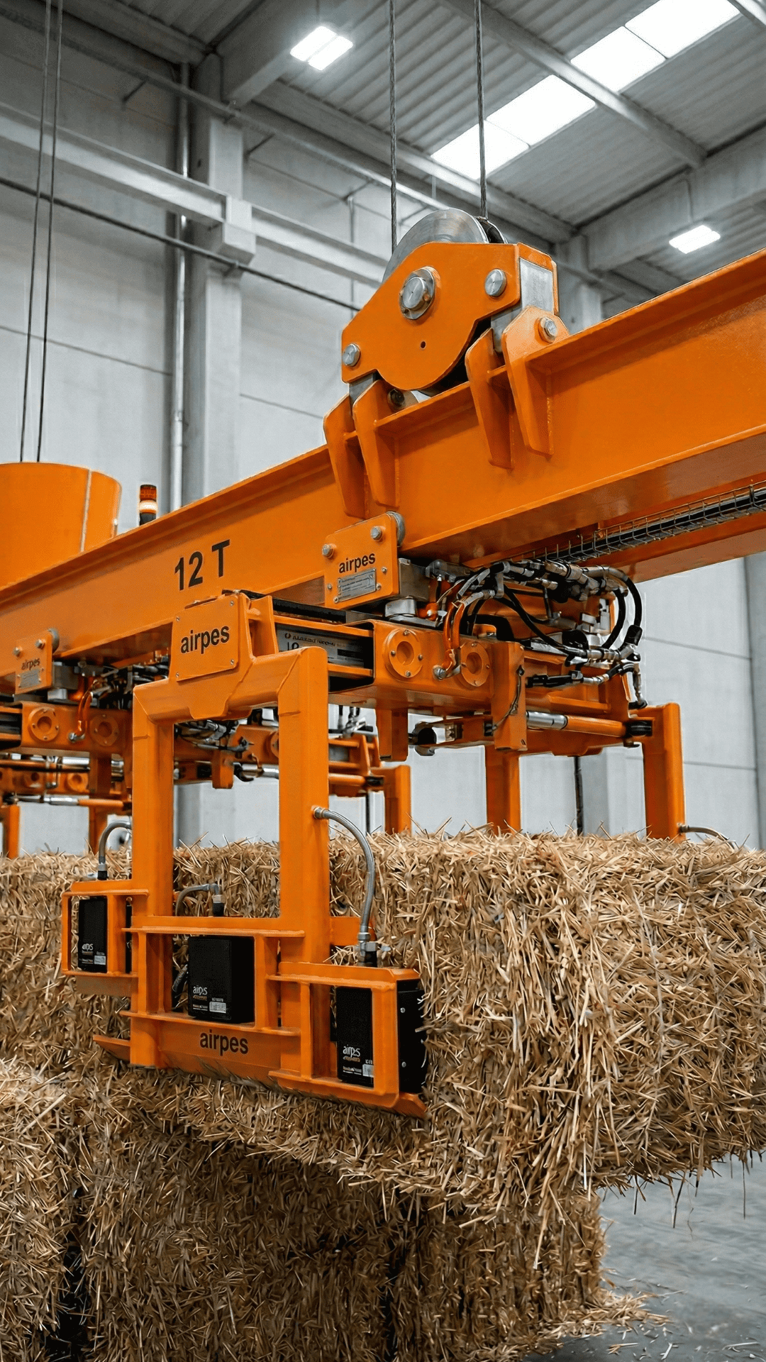 Lifting beam for straw bale handling as part of a biomass fuel handling system